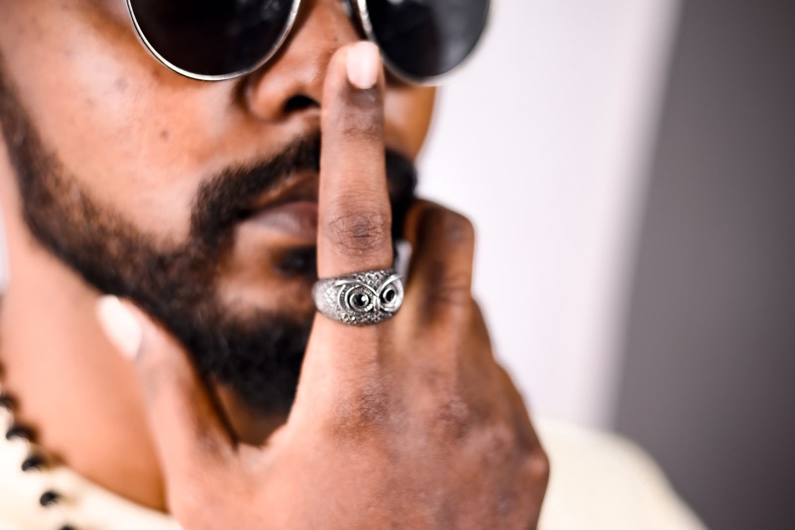Steel owl ring worn on index finger
